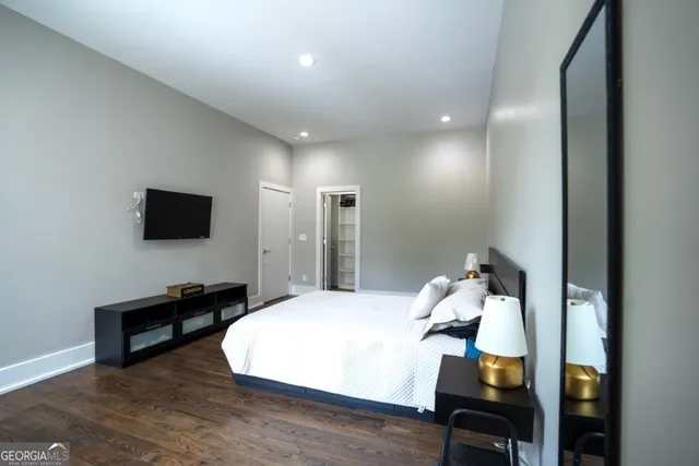 a bedroom with a bed and a flat screen tv