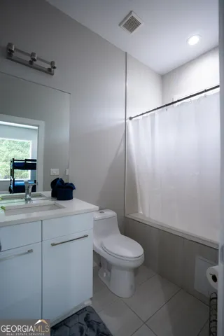 a bathroom with a toilet a sink and a shower