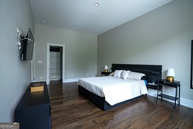 a bedroom with a bed and a lamp on table