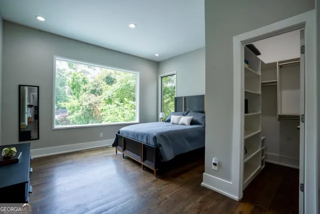 a living room with a bed and large window