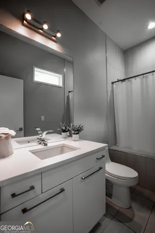 a bathroom with a toilet a sink and a mirror