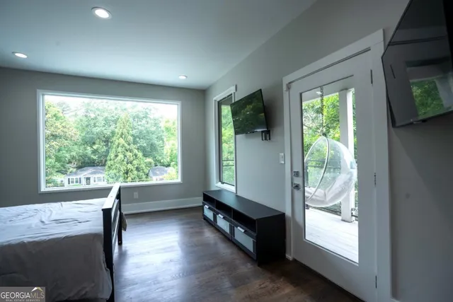 a view of hallway with furniture and a large window