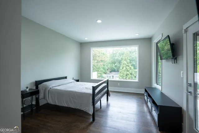 a bedroom with a bed and a large window