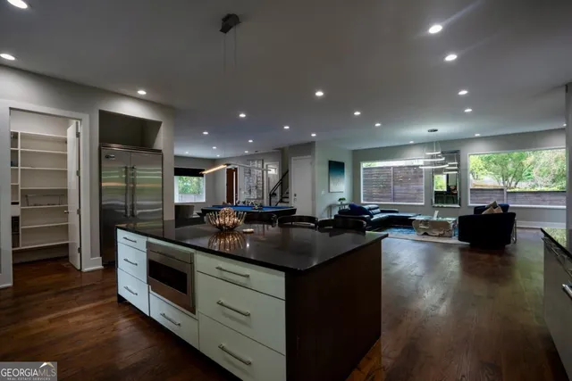 a kitchen with stainless steel appliances granite countertop counter space a stove and a wooden floors