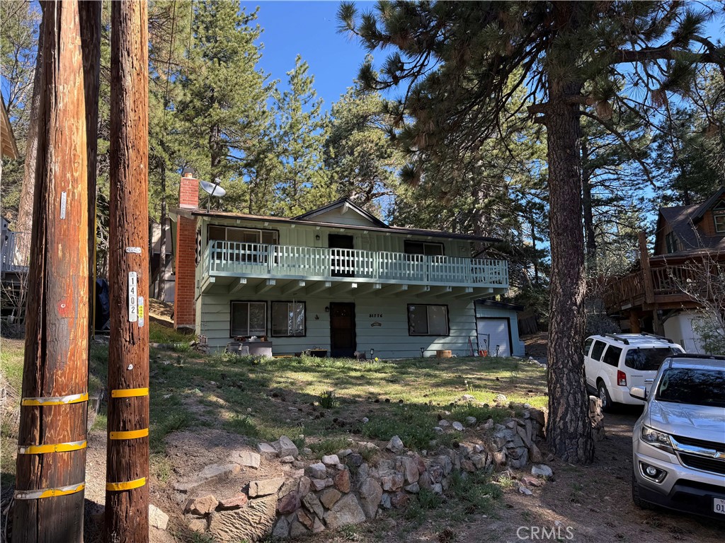 a view of a house with pool and sitting area