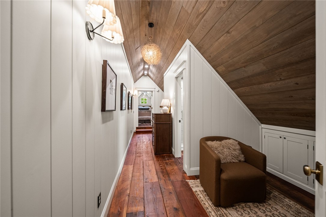 425 Barnhardt Road Timbo, AR 72680 - Photo 47 of 60 Hallway featuring wide plank wood-finish flooring, vertical paneling, and an angled wood-paneled ceiling