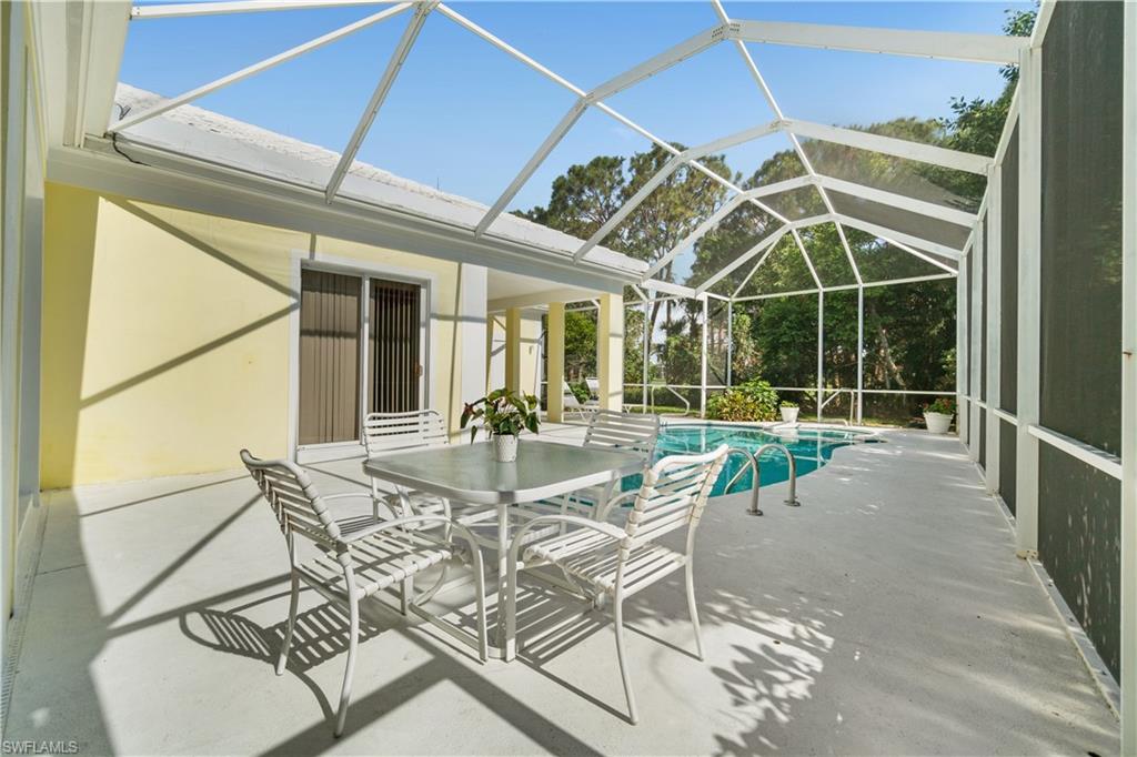 736 Ashburton Drive Naples, FL 34110 - Photo 16 of 37 a view of a dining room with furniture and floor to ceiling window