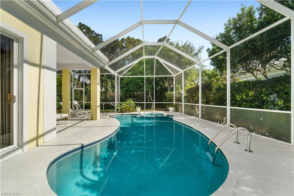 736 Ashburton Drive Naples, FL 34110 - Photo 17 of 37 a view of a swimming pool with a patio and a yard