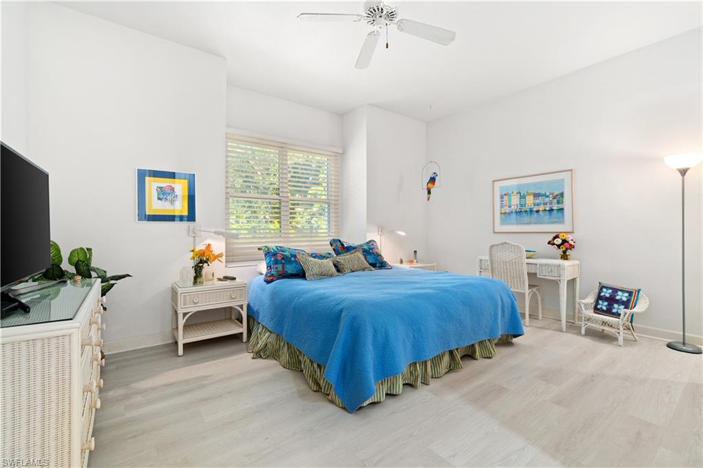 736 Ashburton Drive Naples, FL 34110 - Photo 21 of 37 a bedroom with furniture and a flat screen tv