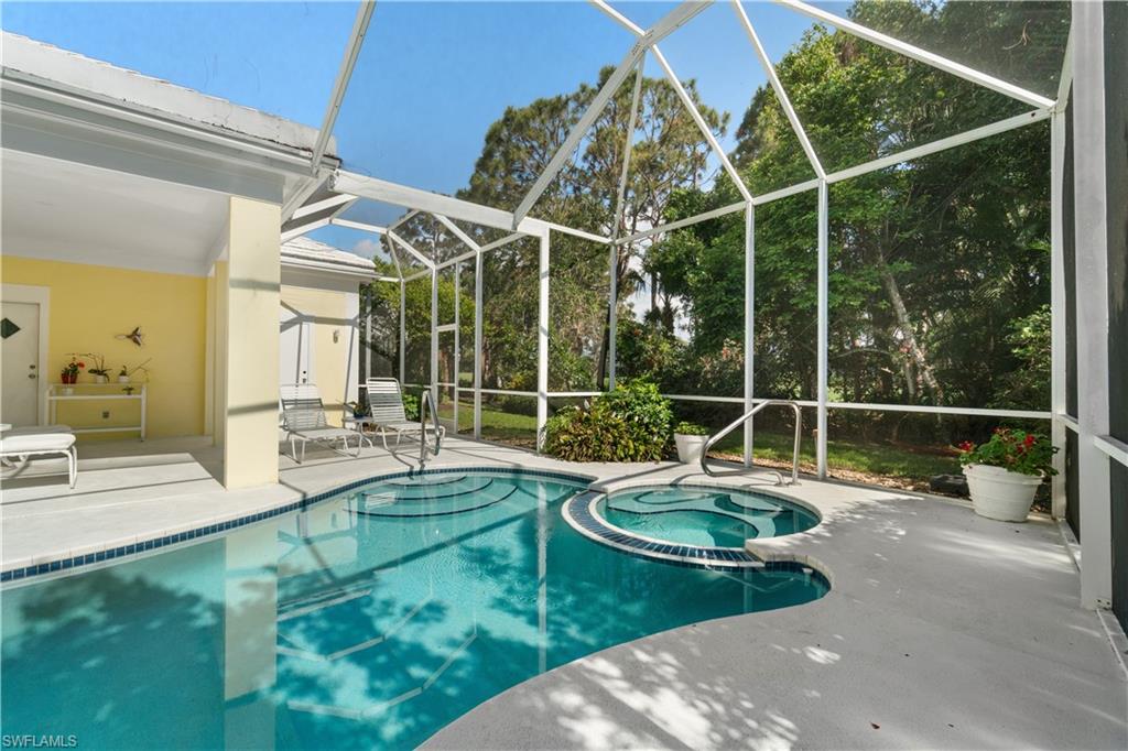 736 Ashburton Drive Naples, FL 34110 - Photo 23 of 37 a view of a house with pool and chairs