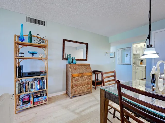 a view of bookshelf with wooden floor and book shelf