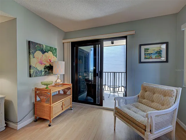 a living room with furniture fireplace and large windows