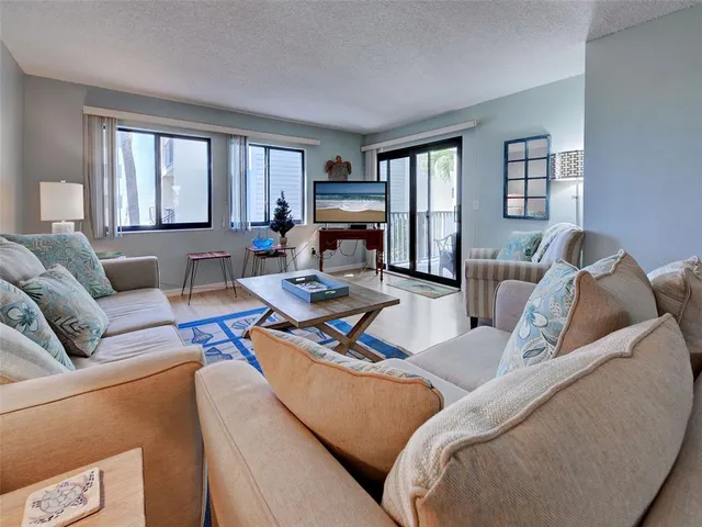 a living room with furniture a rug and a table