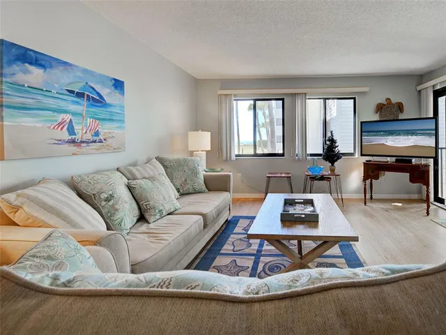 a living room with furniture a rug and a lamp