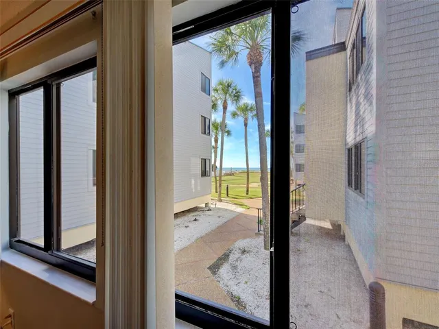 a view of a dining room with furniture a chandelier and window