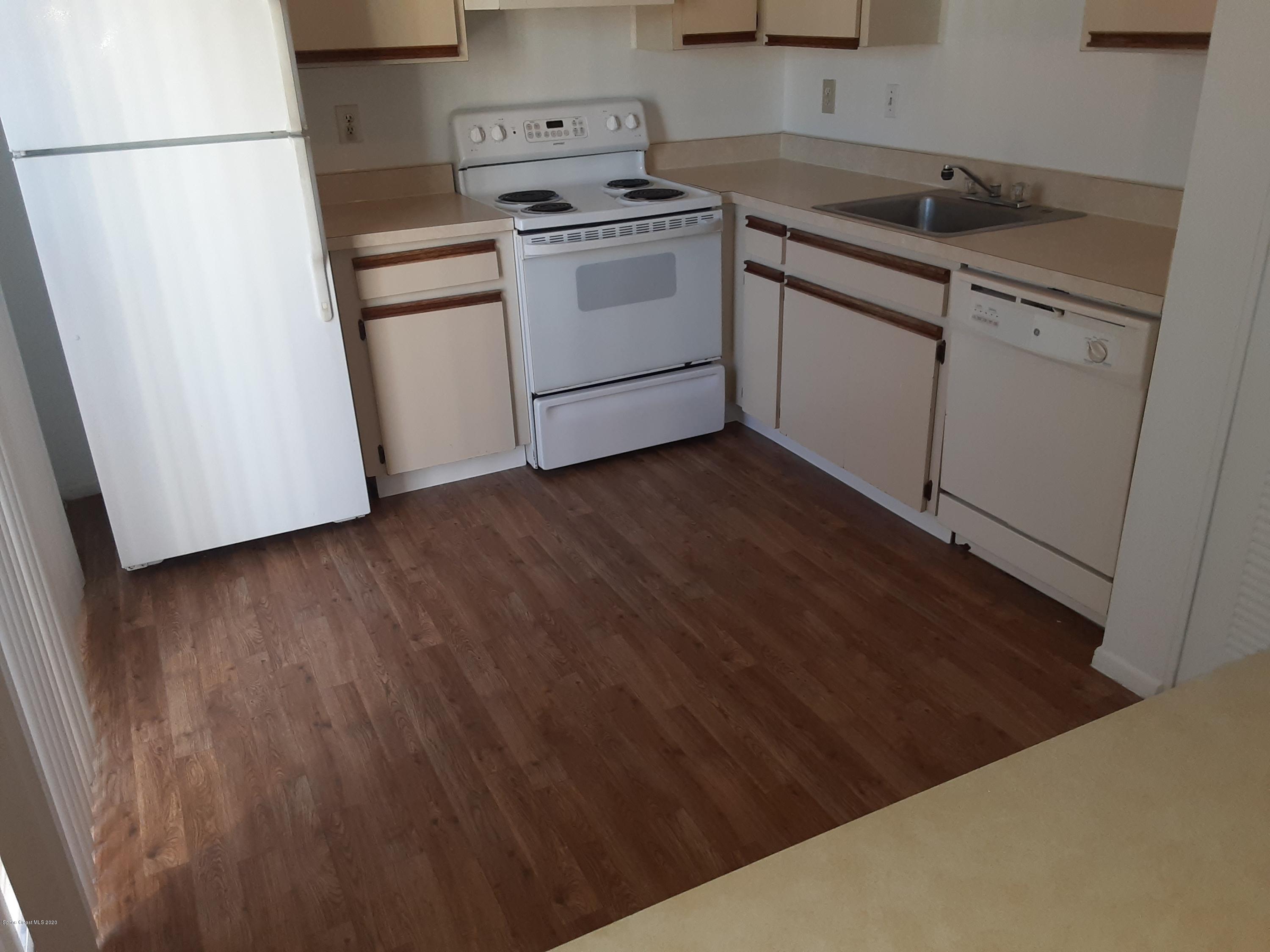 1485 Malibu Circle Northeast, Unit 101 Palm Bay, FL 32905 - Photo 2 of 9 a kitchen with a sink and cabinets