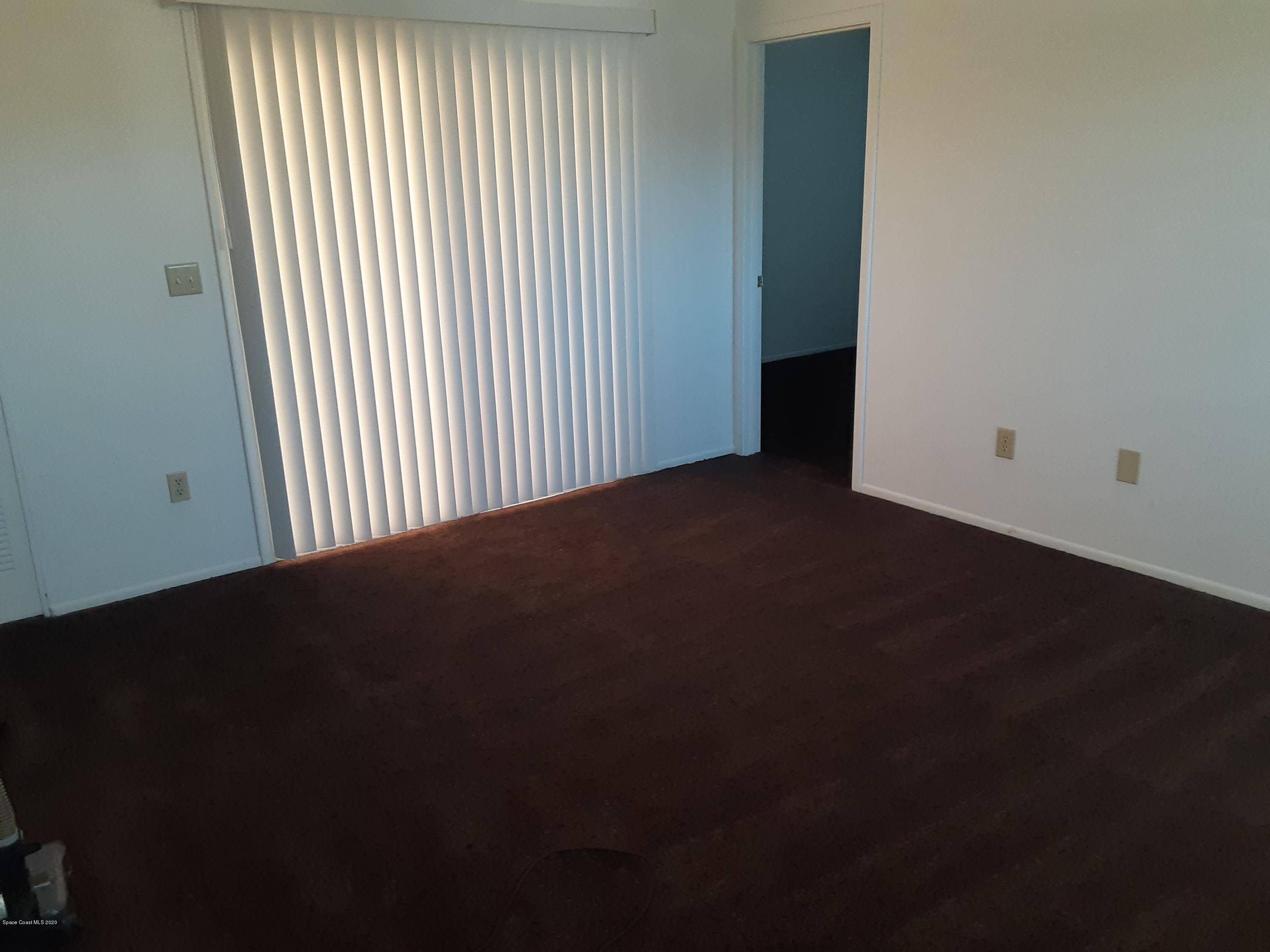 1485 Malibu Circle Northeast, Unit 101 Palm Bay, FL 32905 - Photo 5 of 9 an empty room with a window