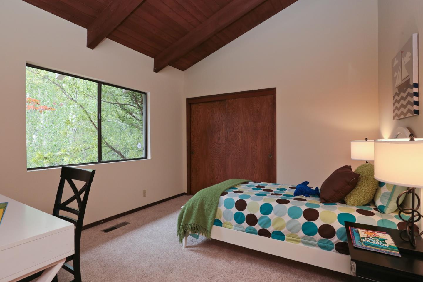 13987 Pike Road Saratoga, CA 95070 - Photo 13 of 28 a bedroom with a bed a dresser next to a window