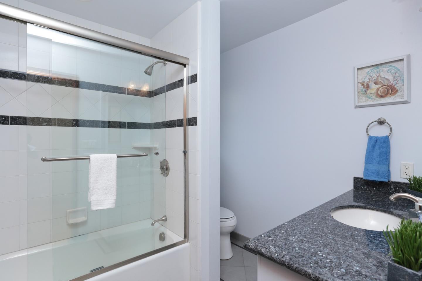 13987 Pike Road Saratoga, CA 95070 - Photo 14 of 28 a bathroom with a granite countertop sink and a mirror