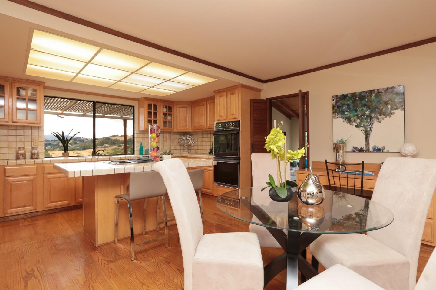13987 Pike Road Saratoga, CA 95070 - Photo 8 of 28 a dining room with furniture a chandelier and wooden floor