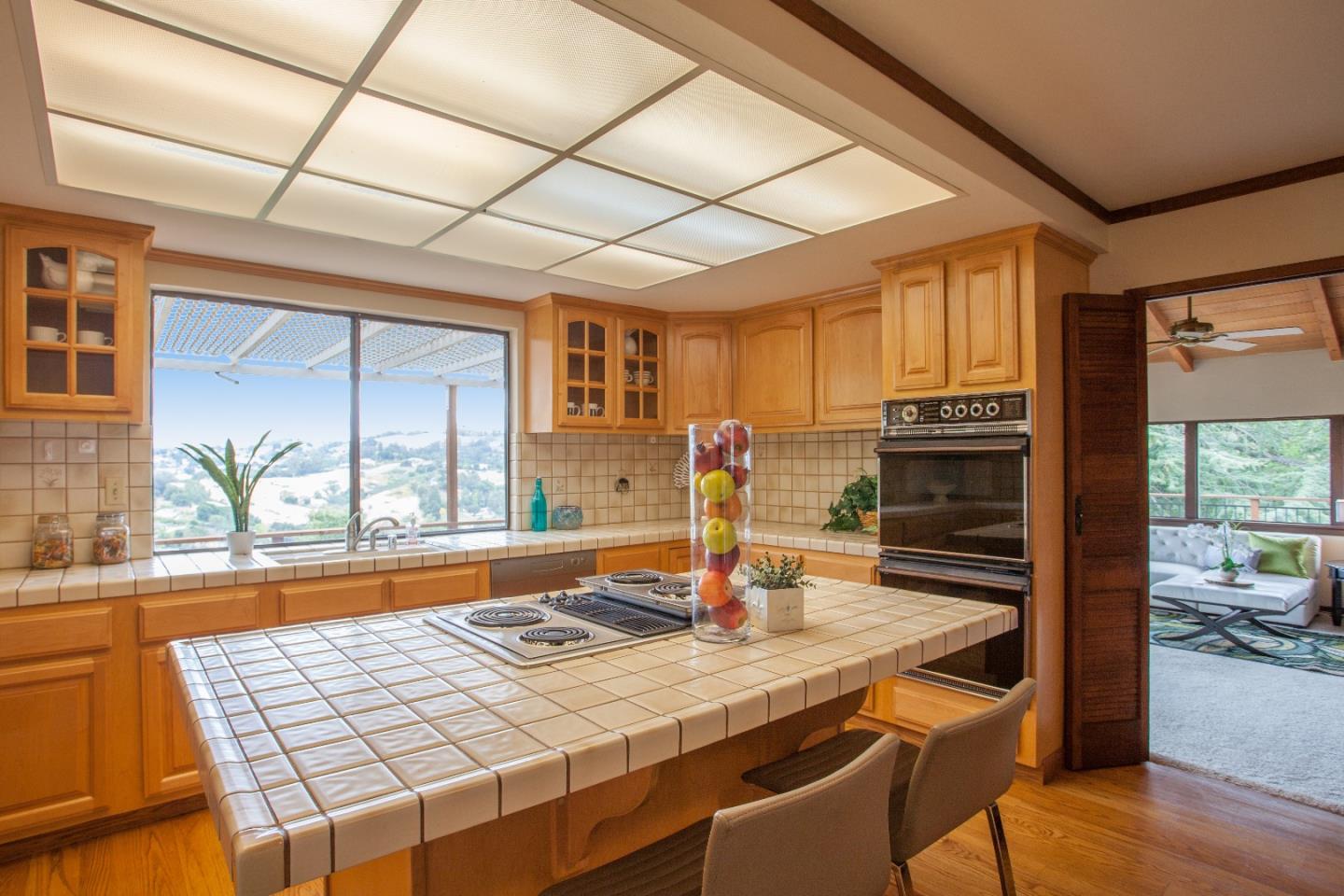13987 Pike Road Saratoga, CA 95070 - Photo 9 of 28 a kitchen with a table and chairs in it