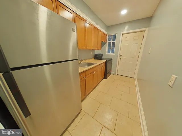 a kitchen with a refrigerator and a stove
