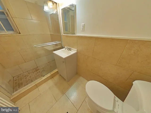 a bathroom with a sink mirror vanity and toilet