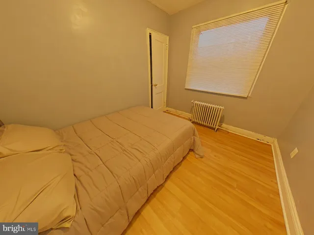 a bedroom with a bed and a mirror