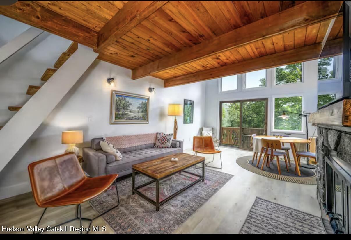 a living room with furniture a fireplace and a large window