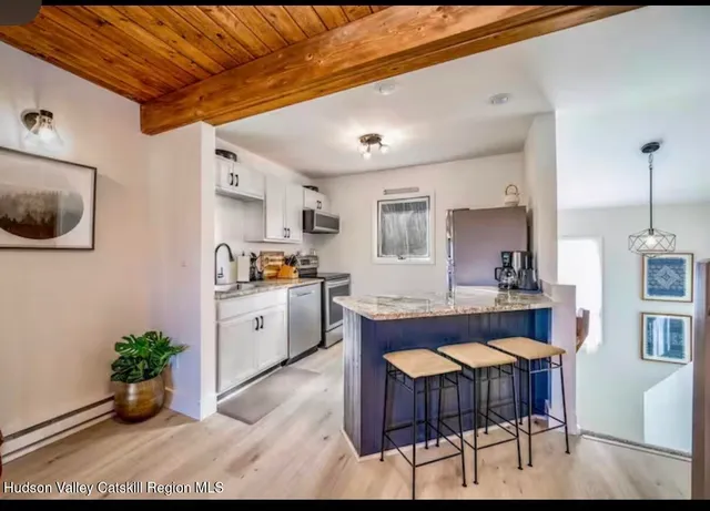 a large kitchen with a table and chairs