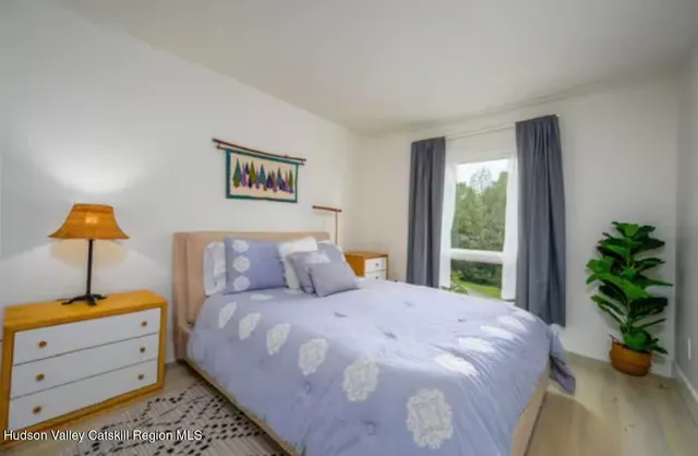 a bedroom with a bed and a window