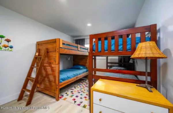 a bedroom with bunk bed and a window