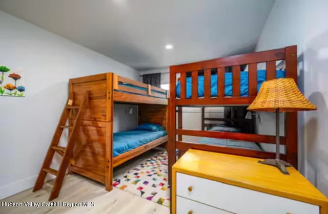 a bedroom with bunk bed and a window