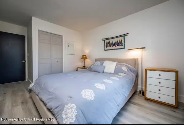 a bedroom with a bed and a night stand