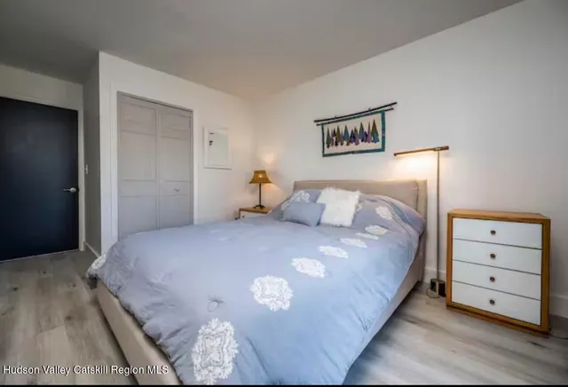 a bedroom with a bed and a night stand