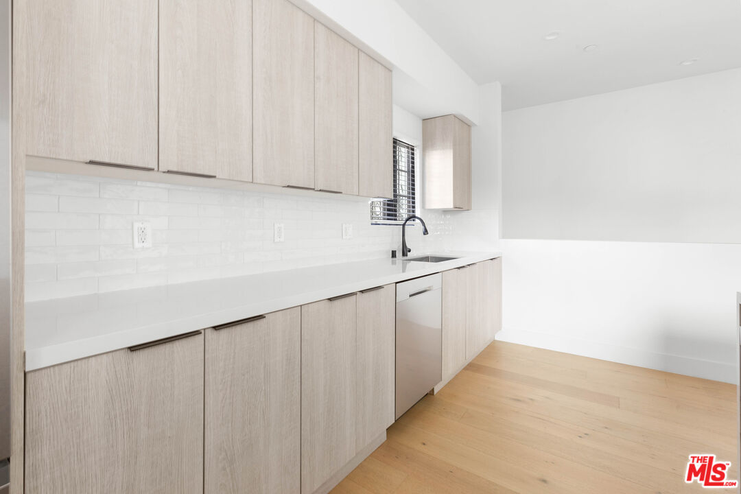 736 Parkman Avenue Los Angeles, CA 90026 - Photo 16 of 34 a bathroom with a sink and a white cabinet