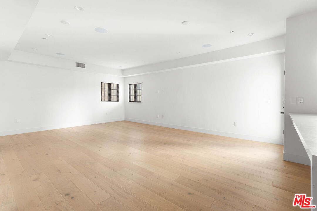 736 Parkman Avenue Los Angeles, CA 90026 - Photo 18 of 34 a view of an empty room with wooden floor and a window