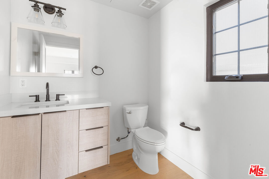 736 Parkman Avenue Los Angeles, CA 90026 - Photo 19 of 34 a bathroom with a sink a toilet and mirror