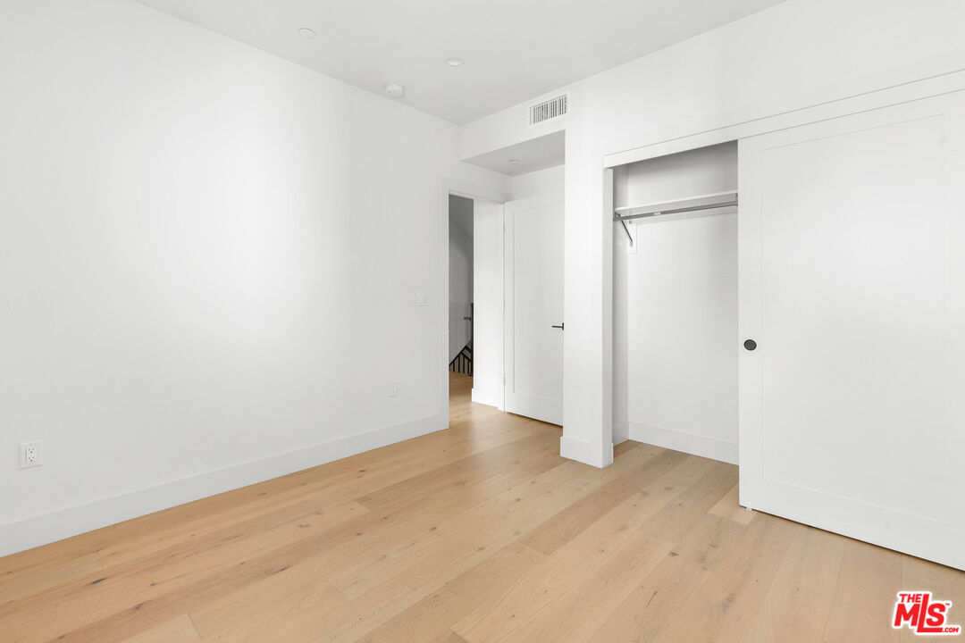 736 Parkman Avenue Los Angeles, CA 90026 - Photo 23 of 34 a view of an empty room with wooden floor