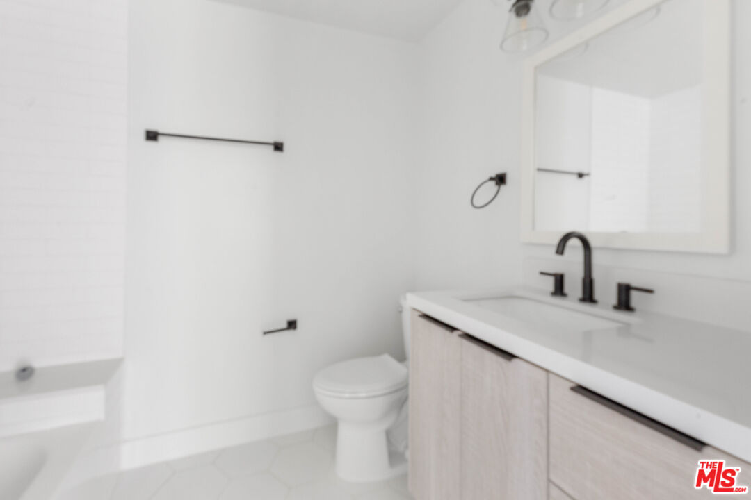 736 Parkman Avenue Los Angeles, CA 90026 - Photo 24 of 34 a bathroom with a sink toilet and a mirror