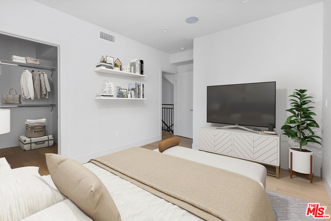 736 Parkman Avenue Los Angeles, CA 90026 - Photo 27 of 34 a bedroom with a bed and a flat screen tv