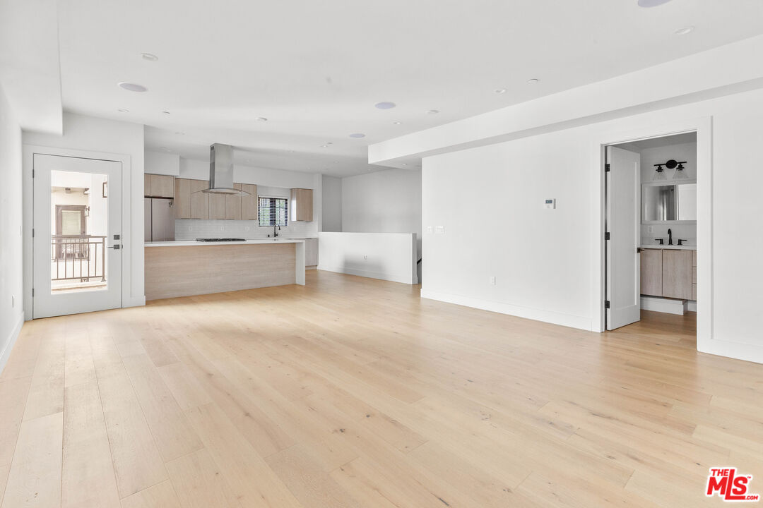 736 Parkman Avenue Los Angeles, CA 90026 - Photo 8 of 34 a large white kitchen with kitchen island a sink stainless steel appliances and cabinets
