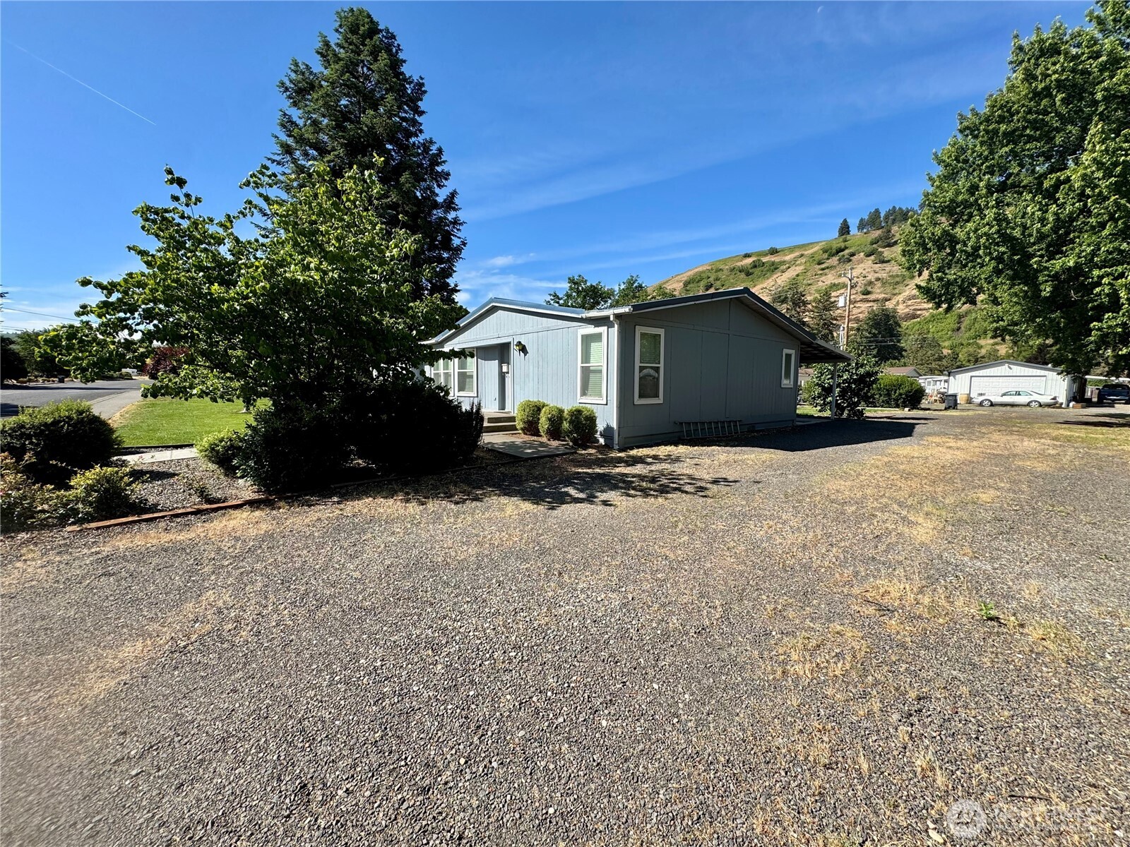 1218 South 3rd Street Dayton, WA 99328 - Photo 3 of 23 a view of a house with a snow yard and a large tree