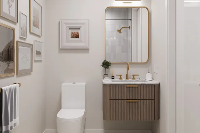 a bathroom with a toilet a sink a vanity and mirror