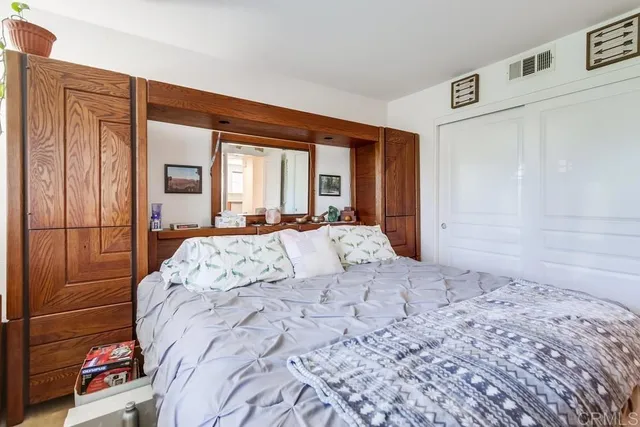 a bed sitting in a bedroom next to a window