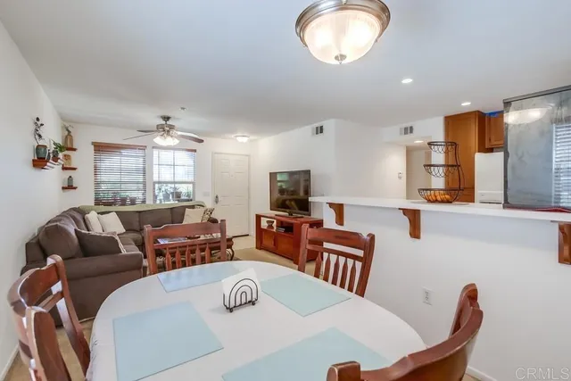 a living room with furniture a large window and a flat screen tv