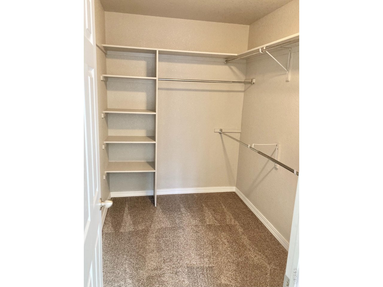 1900 68th Avenue, Unit 5 Greeley, CO 80634 - Photo 13 of 21 a view of an empty walk in closet with empty racks