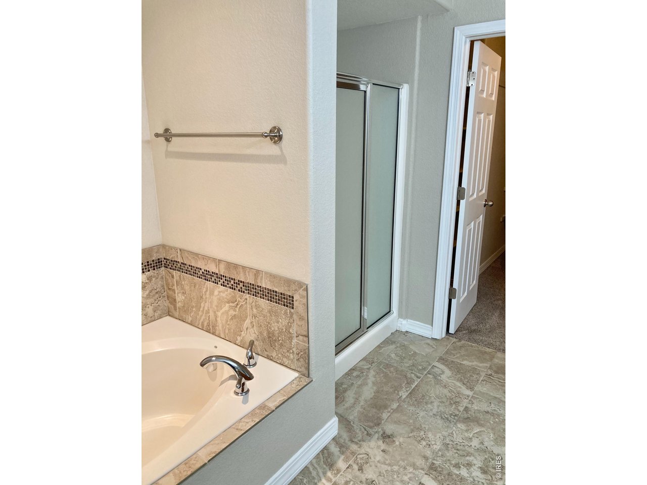 1900 68th Avenue, Unit 5 Greeley, CO 80634 - Photo 14 of 21 a bathroom with a tub and a shower