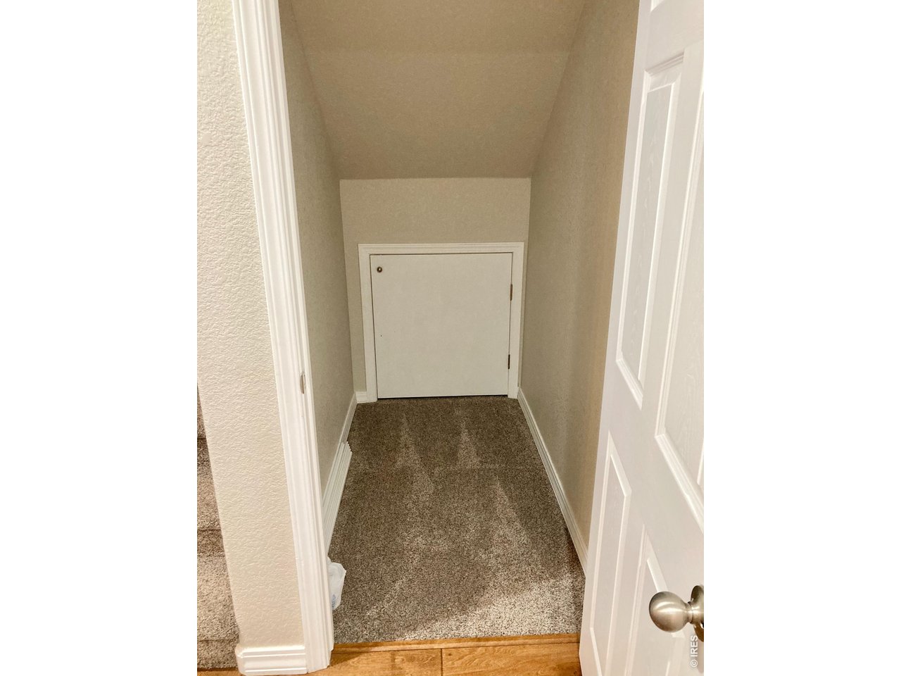 1900 68th Avenue, Unit 5 Greeley, CO 80634 - Photo 16 of 21 a view of a hallway with white walls and a window