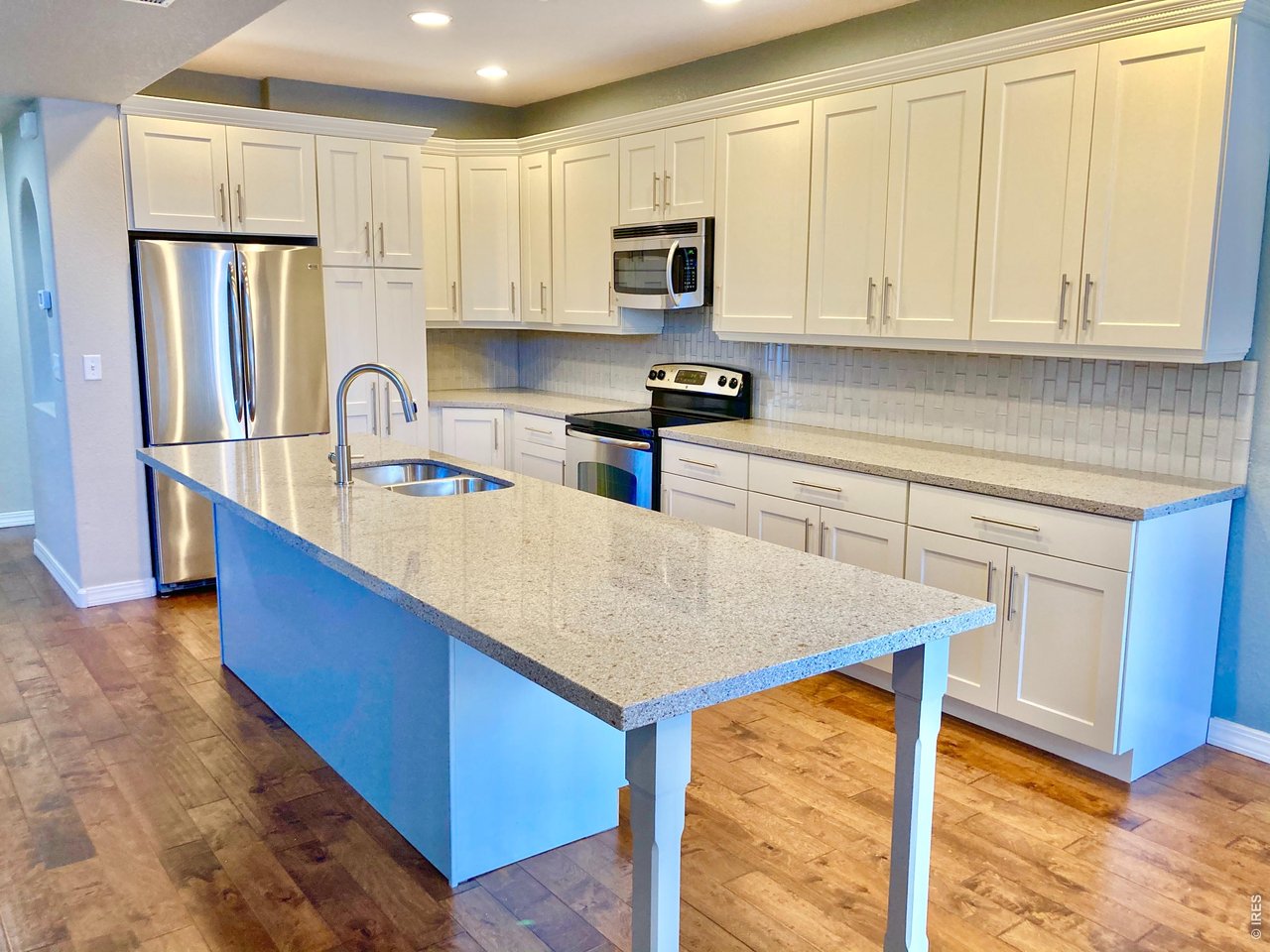 1900 68th Avenue, Unit 5 Greeley, CO 80634 - Photo 2 of 21 a kitchen with stainless steel appliances granite countertop a sink a stove a refrigerator a center island and cabinets
